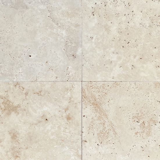 A photo of the surface of a Ivory travertine tile.