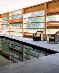 Dark natural stone pavers around an indoor pool area.