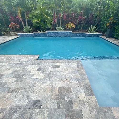 travertine tiles around a pool