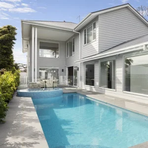 A picture of White Granite pavers around a pool in Melbourne.